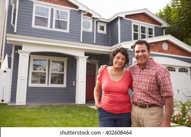 Portrait Of Senior Hispanic Couple Standing Outside House