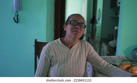 Portrait Of A Senior Hispanic Woman At Home. Casual Mature Older Lady With Glasses Looking At Camera