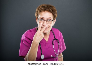 Portrait Of Senior Lady Doctor Gesturing Look Into My Eyes On Black Background