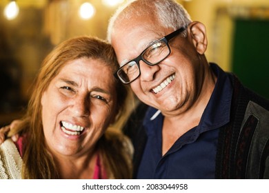 Portrait Of Senior Latin Couple Having Tender Moment Together - Focus On Man Face