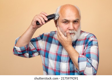 Portrait Of Senior Man Being Trimmed With Professional Electric Clipper Machine In Barbershop, Haircut With An Electric Razor.