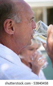 Portrait Of A Senior Man Drinking A Glass Of Water