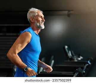Portrait of a senior man exercising in a gym, mature male running using treadmill machine equipment, healthy lifestyle and cardio exercise at fitness club concepts, vitality and active training coach  - Shutterstock ID 2357502399