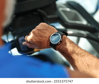 Portrait of a senior man exercising in a gym, mature male running using treadmill machine and checking smart watch for performance, healthy lifestyle and cardio exercise at fitness club concepts - Powered by Shutterstock