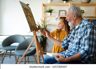 Portrait Of Senior Man, Grandfather Teaching Children Painting. Happy Family Time