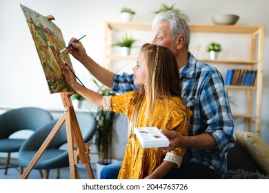 Portrait Of Senior Man, Grandfather Teaching Children Painting. Happy Family Time