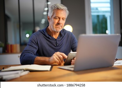 Portrait Of Senior Man With Grey Hair Connected With Laptop