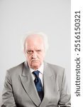 Portrait, senior man and grumpy in studio, unhappy and upset for loss of business, angry and professional. White background, formal and CEO of company, accountant and retirement of mature person