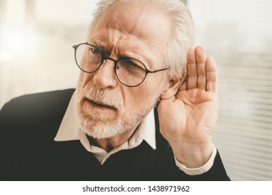 Portrait Of Senior Man Having Hearing Problems