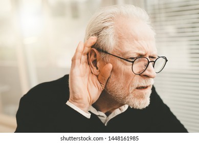 Portrait Of Senior Man Having Hearing Problems