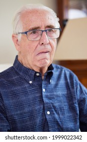 Portrait Of Senior Man At Home Suffering From Stroke Showing Dropped Side Of Face