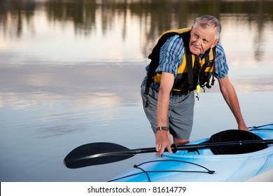 Portrait Of Senior Man With Kayak