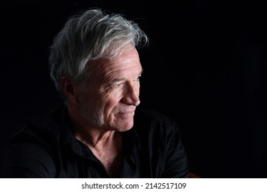 Portrait Of Senior Man Looking Away  On Black Background