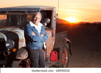 Portrait Of Senior Man Next To His Vintage Truck