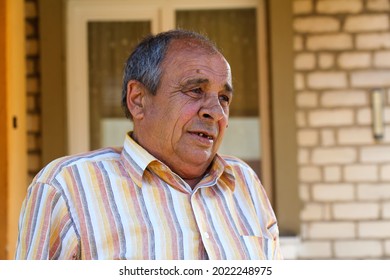 Portrait of a senior man outdoors. 70s years old latin or hispanic man standing outside in summer day. Casual and lifestyle concept.