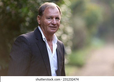 Portrait Of A Senior Man Outdoors. Young Handsome Smiling Man Outdoor Portrait . 