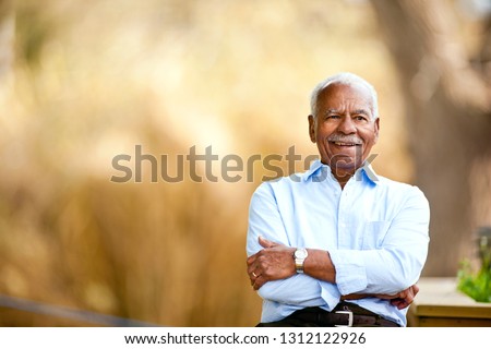 Portrait of senior man outside.
