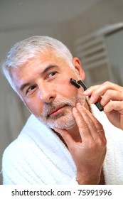 Portrait Of Senior Man Shaving Beard