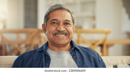 Portrait, senior man and smile in home to relax for retirement, confidence and good mood. Happy face, elderly guy and pensioner on sofa in living room with wisdom, old age and optimism in Colombia - Powered by Shutterstock