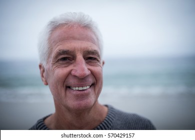 Portrait Of Senior Man Smiling At Beach