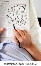 Portrait Of A Senior Man Solving Crosswords Puzzles