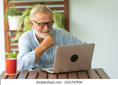 Portrait senior man using laptop for working at home, Freelance concept - Image - Powered by Shutterstock