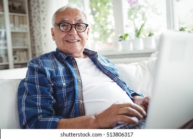 Portrait Of Senior Man Using Laptop At Home