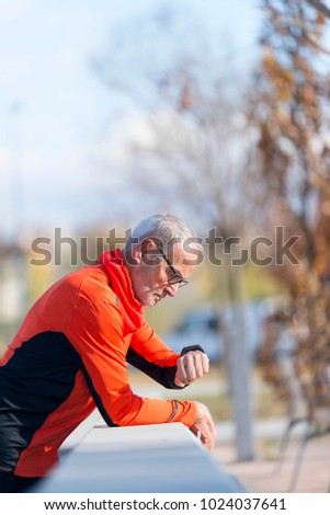 Similar – Senior runner man sitting after jogging in a park