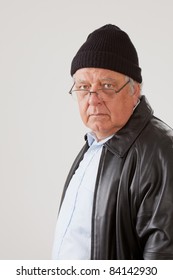 Portrait Of Senior Man Wearing Toboggan Cap And Leather Jacket.