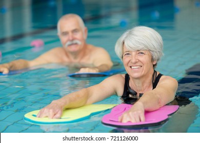 portrait of senior man and woman in swimming pool - Powered by Shutterstock