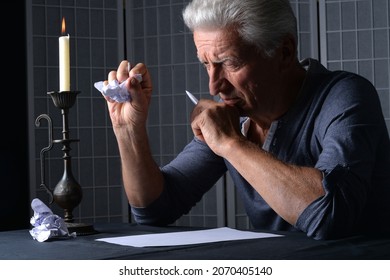 Portrait Of Senior Man Writing A Letter At Home