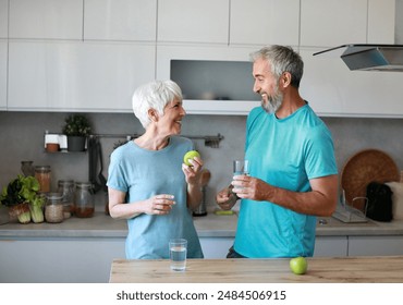 Portrait of a senior mature couple having a healthy breakfast after fitness exercise training in the morning at home - Powered by Shutterstock