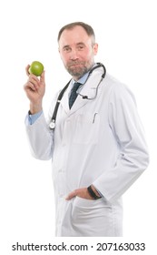 Portrait of a senior medical doctor holding a fresh green apple. Isolated on white
