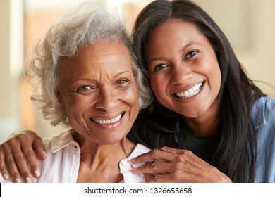 Portrait Of Senior Mother Being Hugged By Adult Daughter At Home - Powered by Shutterstock