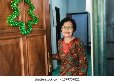 Portrait Of Senior Old Woman At Her House Front Door