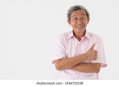 Portrait Of A Senior Older Asian Man Good Positive Looking Pose With Happy And Confident To Camera Rise Hand For Thumb Up On White Background.