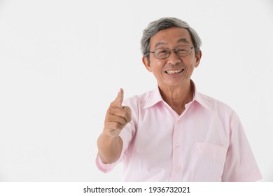 Portrait Of A Senior Older Asian Man Good Positive Looking Pose With Happy And Confident To Camera Point Finger To Camera On White Background.