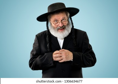 Portrait of senior orthodox jewish man at studio. Purim, festival, holiday, celebration, judaism, religion, human emotions concept.