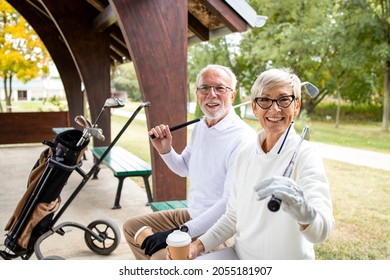 Portrait of senior people in retirement holding golf clubs and ready for golf training.