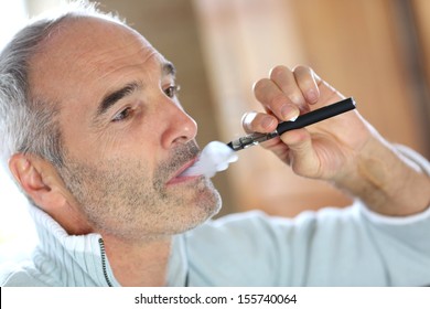 Portrait of senior smoker with electronic cigarette