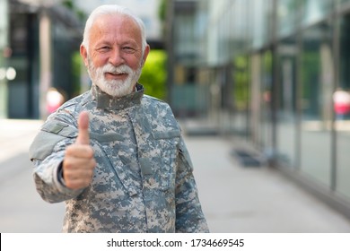 Portrait senior soldier in military uniform holding thumb up - Powered by Shutterstock