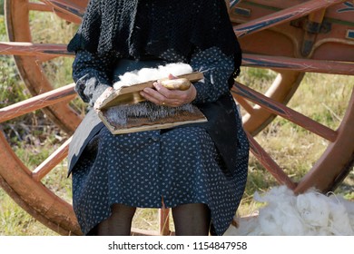 Portrait of a senior woman carding wool - Powered by Shutterstock