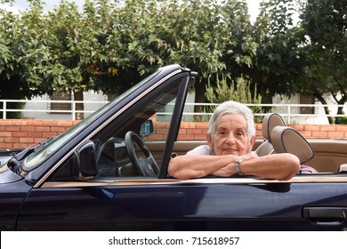 portrait of a senior woman with convertible  - Powered by Shutterstock