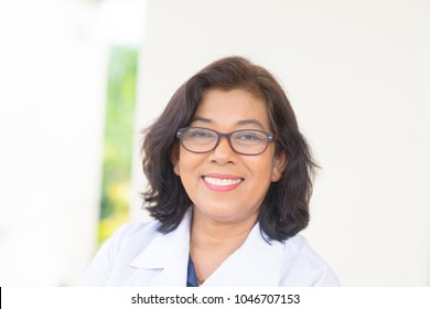 Portrait of senior woman doctor smile in medical office.