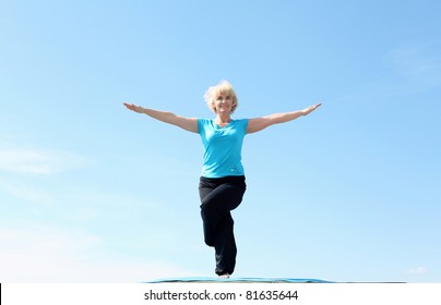 Portrait Of A Senior Woman Doing Yoga Outdoors