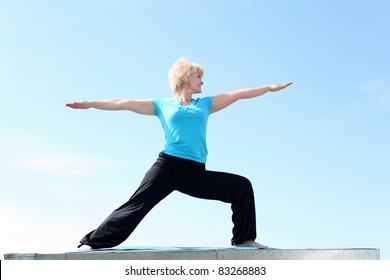 Portrait Of A Senior Woman Doing Yoga Outdoors