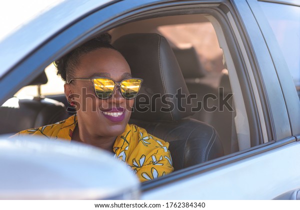 Portrait of a senior woman driving a car.\
Application driver\
concept.