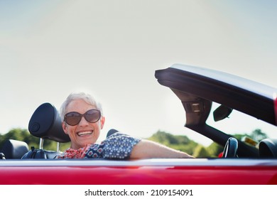 Portrait Senior Woman Driving Convertible