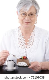 Portrait Of Senior Woman Eating Chocolate Mousse Cake, Smiling At Camera.?