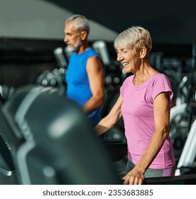 Portrait of a senior woman exercising in a gym, mature couple running using treadmill machine equipment, healthy lifestyle and cardio exercise at fitness club concepts, vitality and active senior,  - Shutterstock ID 2353683885